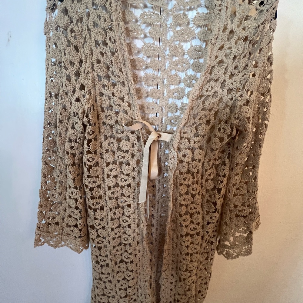 Long light sweater has the look of crochet or lace.  Size S.  See through.